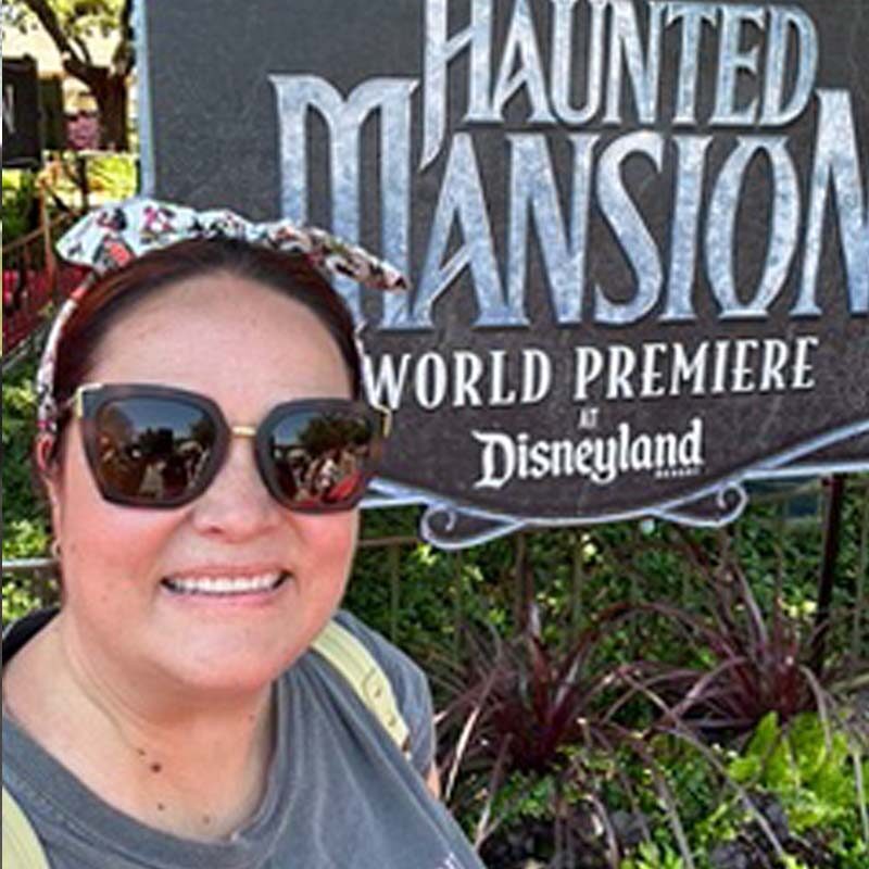 photo of Kristen Olson in front of Haunted Mansion disney ride